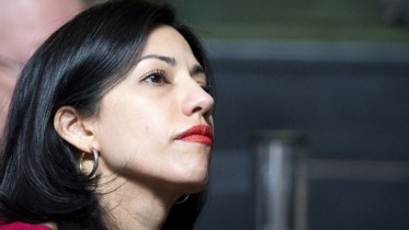 Huma Abedin listens during a speech by democratic presidential candidate Hillary Clinton at the 18th Annual David N. Dinkins Leadership and Public Policy Forum at Columbia University in New York April 29, 2015. REUTERS/Brendan McDermid  - RTX1AUYC
